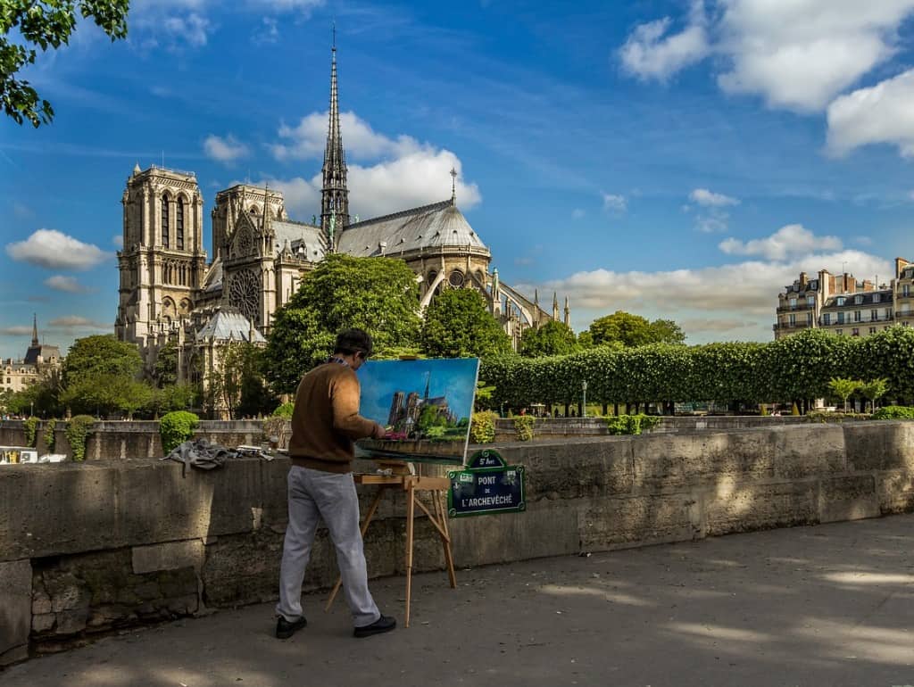 Artist painting the Notre Dame